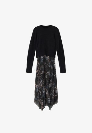 Black long-sleeve sweater paired with a pleated midi skirt featuring a dark abstract floral pattern and uneven hem.