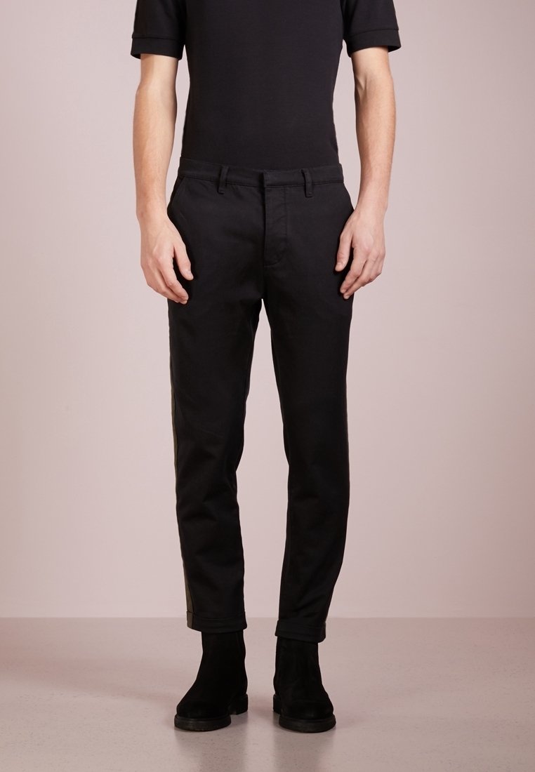Black tailored pants made from a smooth fabric with a slim fit, featuring front pockets and a clean waistband detail.