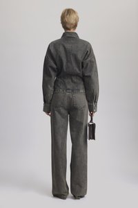 Dark gray denim jacket with a tailored fit and balloon sleeves, paired with matching wide-leg trousers; smooth texture and minimal stitching.