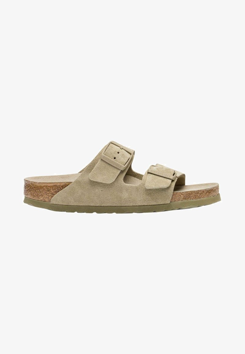 Suede Slide Sandal in beige with two adjustable buckles, cork footbed, and rubber outsole. Low-profile design with a textured upper.