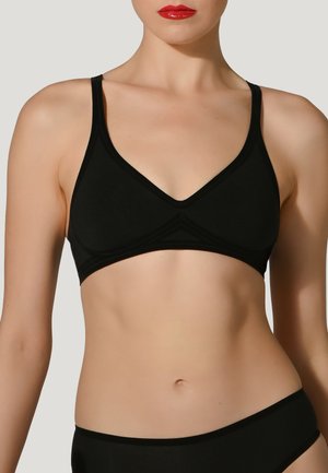 Schwarzer Bralette mit verstellbaren Trägern, V-Ausschnitt-Design und nahtloser Konstruktion. Weicher Stoff mit subtiler Textur, bietet ein minimalistisches Erscheinungsbild.