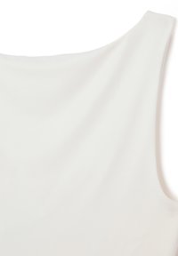 White sleeveless top made of a smooth, soft fabric. Features a rounded neckline and a relaxed fit with minimal stitching detail.