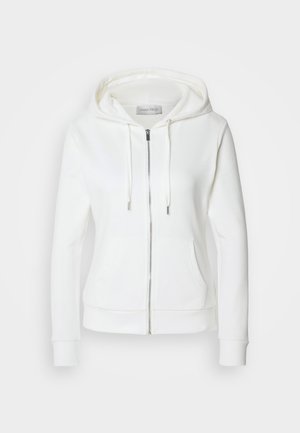 Balta kapuce ar rāvējslēdzēju, mīksta faktūra, ar aukliņu regulējamu kapuci, divām priekšējām kabatām un ribotām aprocēm. Vienkāršs dizains ar tīrām līnijām un bez rakstiem.