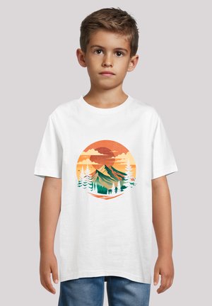 White cotton t-shirt featuring a colorful mountain and forest graphic with orange and yellow sunset background. Short sleeves and round neckline.