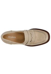 Beige suède loafers met decoratieve stiksels en een licht verhoogd ontwerp op de bovenkant, met een bruine rubberen zool en een glad interieur.