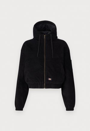 Black cropped jacket made of corduroy fabric, featuring a hood, front zip closure, and elastic cuffs. Includes an embroidered logo detail.