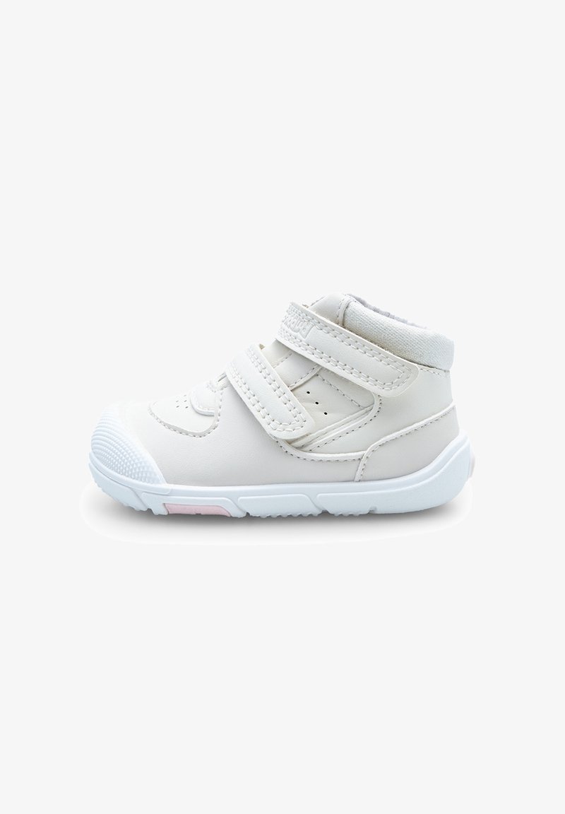 Baskets blanches pour tout-petits avec deux bandes Velcro réglables, col rembourré à la cheville et semelle texturée avec détail rose sur fond blanc.