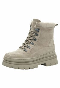 Stivaletti beige con lacci, suola spessa, materiale scamosciato, occhielli metallici e colletto imbottito per un comfort e supporto aggiuntivi.
