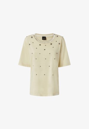 Bež majica kratkih rukava s ukrašenim detaljima i okruglim izrezom s metalnim naglascima. Glatka tkanina sa raspršenim dekorativnim elementima.