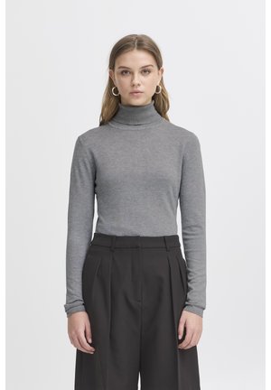 Gray turtleneck sweater in a smooth knit material, paired with high-waisted black pleated trousers. Simple design, long sleeves.