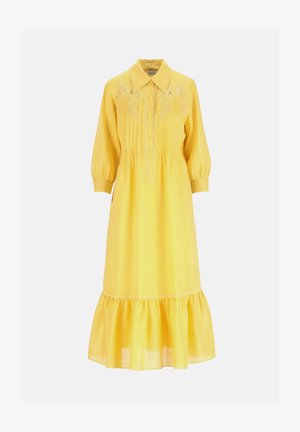 Dzeltena midi kleita ar garām piedurknēm, asu apkakli, ziedu izšuvumu uz krūtīm, pogām aiztaisāmu priekšu, smalkām locījuma līnijām un raupju apakšu.