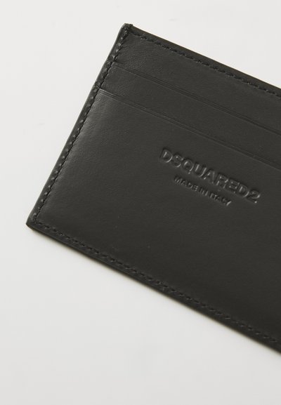 Black leather cardholder with multiple slots, embossed logo "DSQUARED2," and neat stitching along the edges. Smooth texture.