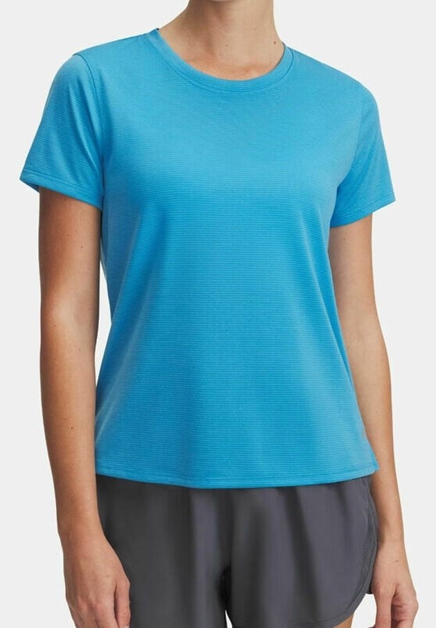 Femme portant un t-shirt de sport ajusté à manches courtes bleu vif texturé et un short de course gris foncé.