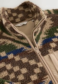 Fleece zip-up jacket with a high collar, featuring a brown, green, and blue geometric pattern; beige zipper detail and lining.
