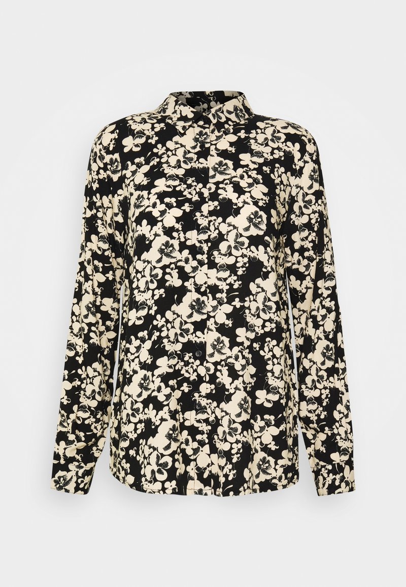 Chemise noire à manches longues avec boutons, motif floral beige et col pointu, présentée sur un fond gris clair uni.
