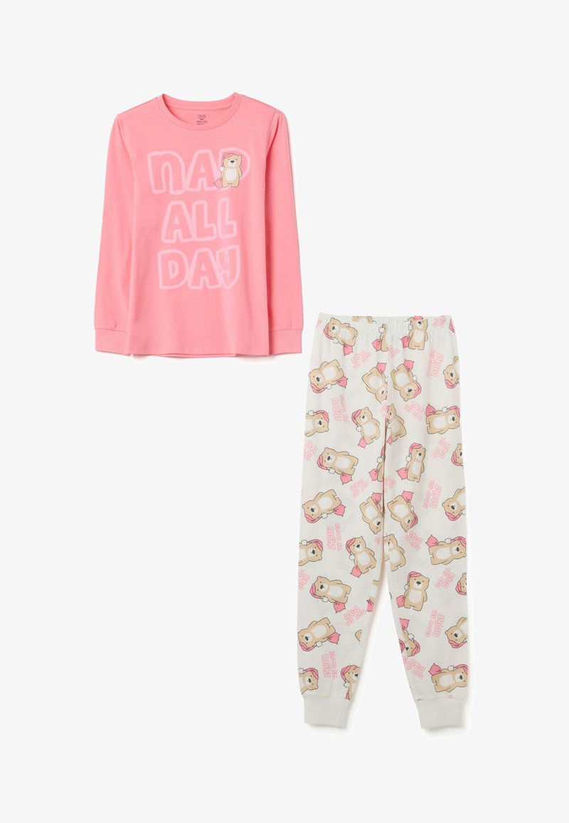 Haut de pyjama à manches longues rose avec le texte "DORMIR TOUTE LA JOURNÉE", associé à un pantalon blanc avec des ours en cartoon et des accents roses. Tissu doux, coupe décontractée.