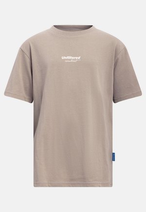 Beżowa koszulka z krótkim rękawem i okrągłym dekoltem, z napisem "Unfiltered content" w kolorze białym na piersi oraz małą niebieską metką po boku.