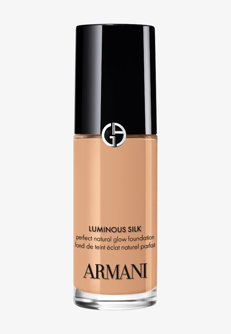 Bottle of Armani Luminous Silk foundation with black cap and beige liquid visible inside.