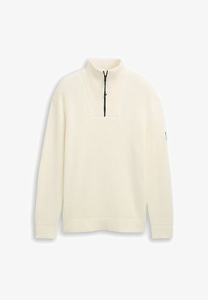 Maglione crema con collo alto e zip a metà, caratterizzato da un motivo in maglia testurizzato e polsini e orlo a costine.