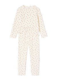 Two-piece pajama set made of soft fabric in cream, featuring a scattered red heart pattern, long sleeves, and a knotted decorative detail at the waist.