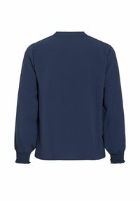 Blouse bleu marine à manches longues avec poignets smockés et ourlet droit, vue de dos sur fond blanc.