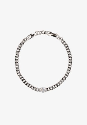 Wykonana z srebrny metalowego łańcuszka bransoletka z naprzemiennymi płaskimi i okrągłymi ogniwami, z centralnym akcentem w postaci przezroczystego kamienia. Gładka faktura i wypolerowane wykończenie.