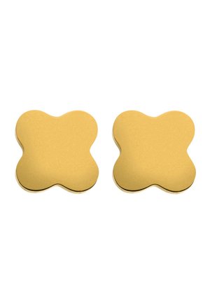 Goldfarbene Silikonuntersetzer in organischer, abgerundeter Form mit glatter Textur und matter Oberfläche, verkauft im Paar.