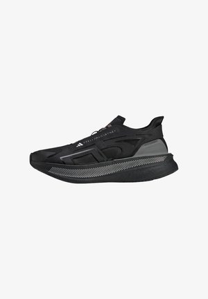 Black athletic shoe featuring a sleek design, mesh upper, and a textured rubber sole with white diagonal stripes. Branding on the side.