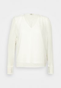 Blusa bianca a maniche lunghe con scollo a V e motivo a pois testurizzato. Presenta maniche gatherate e bordo in pizzo sui polsini.