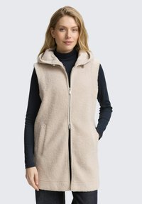Beige Imitationsfellweste mit Reißverschluss vorne, Kapuze und zwei seitlichen Taschen. Das Kleidungsstück zeichnet sich durch eine weiche Textur und einen entspannten Schnitt aus.