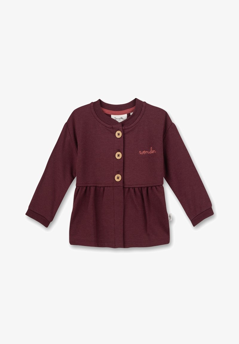 Cardigan bébé à manches longues bordeaux avec trois boutons en bois et "wonder" brodé sur la poitrine, détail de taille froncée.