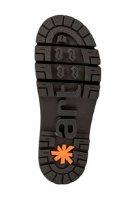 Semelle de chaussure en caoutchouc noir avec des crans profonds, arborant le mot "art" en relief et une étoile orange en accent au centre.