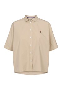 Beige kortärmad skjorta med knappkrage. Har en diskret broderad emblem på bröstet och en rundad fåll. Slät tygstruktur.