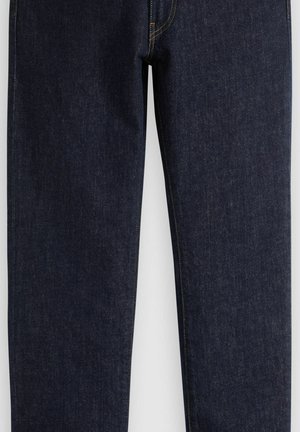 Donkere blauwe spijkerbroek met rechte pijpen en zichtbare gele stiknaden langs de naden en zakken.