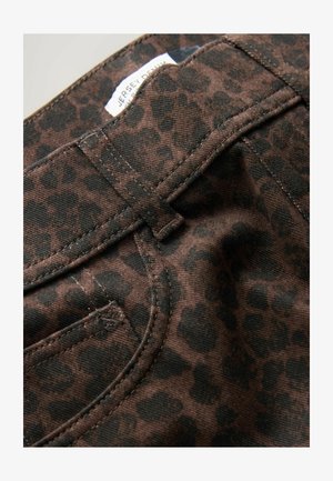 Brown fabric with a black leopard print pattern. Features stitched seams and a label visible near the waistband. Texture appears soft.