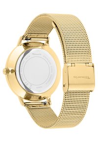 Gold mesh-Armbanduhren mit einem Gehäuse aus Edelstahl, rundem Zifferblatt und glattem Rückenteil. Mit einer Schließe befestigt, zeichnet sie sich durch ein minimalistisches Design aus.