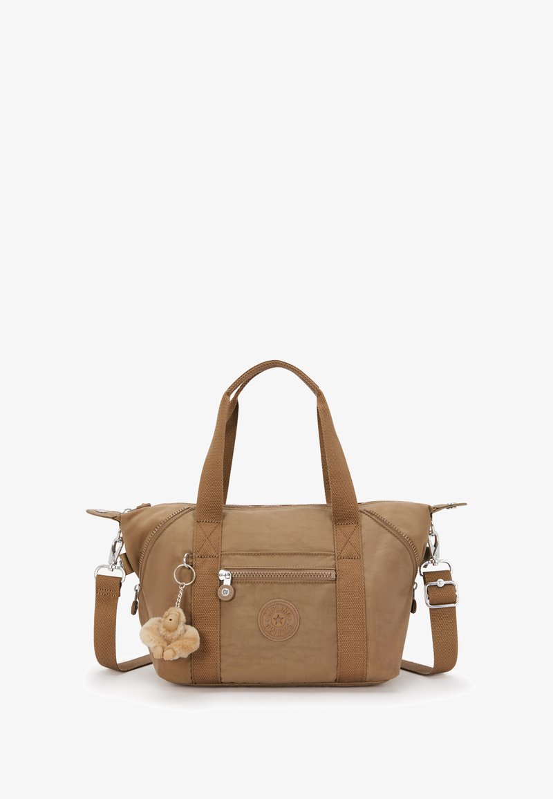 Brązowa torebka materiałowa z dwoma krótkimi uchwytami i odpinanym paskiem na ramię. Posiada przednią kieszeń na zamek oraz futrzany charms przyczepiony do torebki.