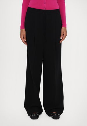 Black wide-leg pants with a drawstring waist, made from a smooth, lightweight fabric. Features double pleats and a relaxed fit.