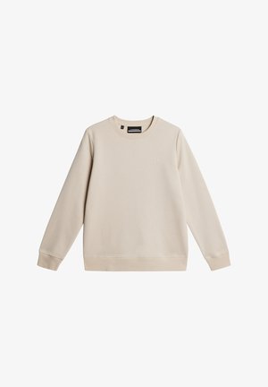 Crewneck sweatshirt i ljusbeige tyg; har ribbade ärmar, rak fåll och ett präglat märke på framsidan.