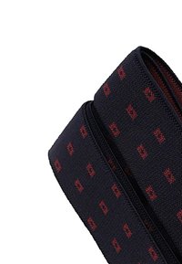 Black textile strap with red geometric pattern, featuring a smooth texture and sturdy zip closure. Suitable for carrying small items.