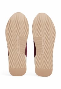 Shoe soles feature a herringbone pattern with a textured surface. Color scheme includes burgundy, cream, and tan. Marked with "TOMMY HILFIGER."