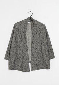 Gray and black textured open-front knit cardigan with three-quarter sleeves hanging on a black hook against a white background.