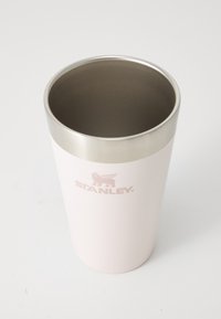 Stainless steel tumbler with a matte pink exterior, silver rim, and the brand "STANLEY" embossed in light pink. Smooth texture, cylindrical shape.