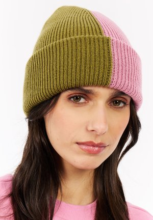 Knit beanie with a two-tone design: olive green and pink. Features ribbed texture and a rolled hem. Suitable for cool weather.