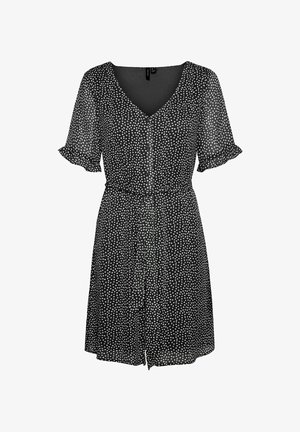 Melnas īsām piedurknēm kleita ar baltām punktiņām, V-veida kakla izgriezums, pogu aizdare un savilkti viduklis. Izgatavota no viegla, caurredzama auduma.