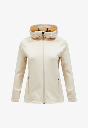 Beige zip-up jacket with a hood, featuring a white "PEACE" band, raglan sleeves, and two zippered side pockets. Smooth texture, minimalist design.
