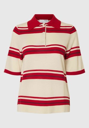 Kortärmad polo i krämfärg med röda och marinblå horisontella ränder. Har en röd krage och tre knappar framtill. Mjuk stickad textur.