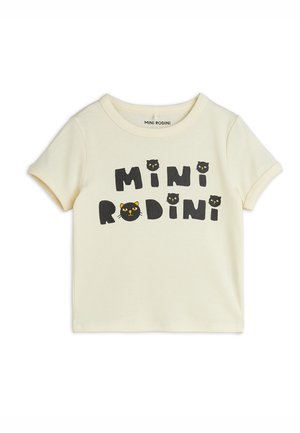 Cremefarbenes T-Shirt mit kurzen Ärmeln, mit dem Text „"MINI RODINI"“ und Cartoon-Schwarze-Katzen-Gesichtern auf der Vorderseite bedruckt.