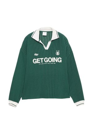 Zeleni rebrasti dukserica s dugim rukavima i bijelim ovratnikom i manžetama. Sprijeda se nalazi natpis "POČNI" u bijeloj boji, s logotipom branda i godinom 1991.
