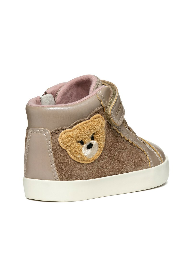 Sneaker alla caviglia beige e marrone con applicazione di orsetto, strap in velcro, suede texturizzato, pelle liscia e suola in gomma bianca.